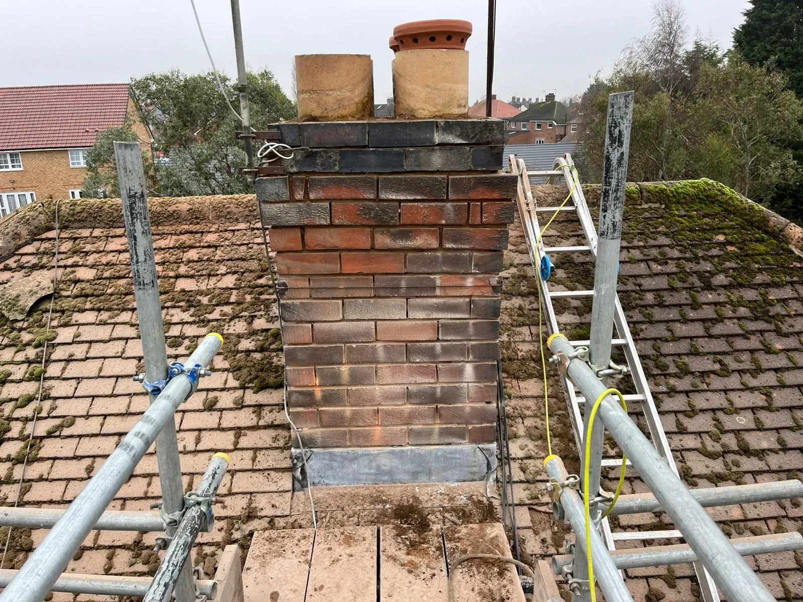 Expert chimney repairs and maintenance being carried out on a house in Gloucestershire by PRS Roofing.